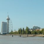 a large body of water with a tall building in the background